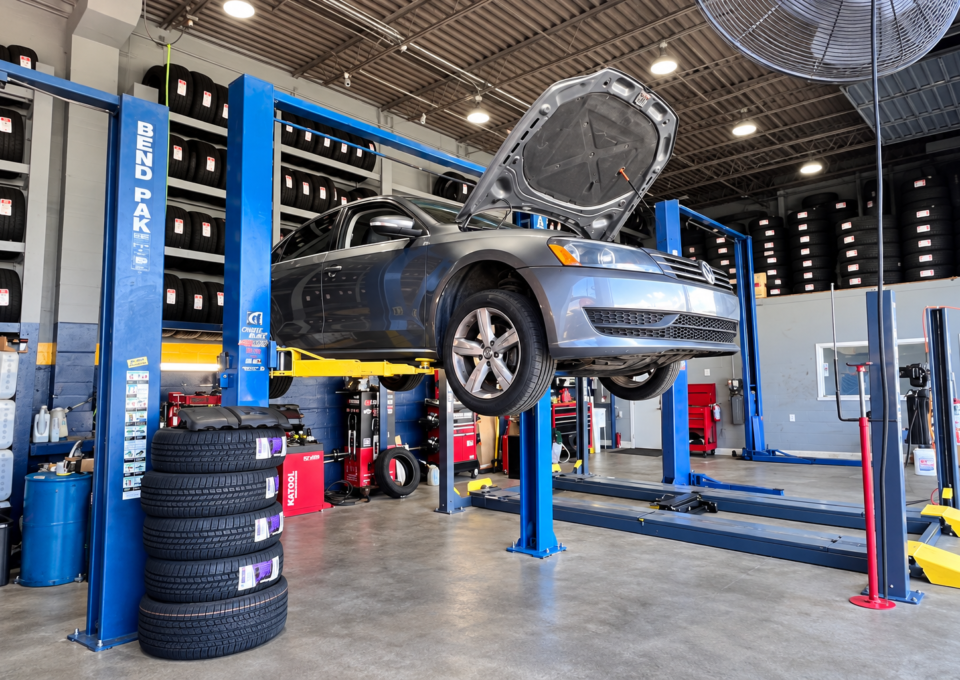 Car on a lift inside Broward Tire & Mechanic Shop in Fort Lauderdale
